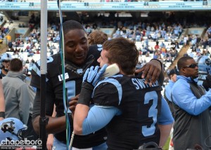 Marquise Williams and Ryan Switzer share a call with the coaching staff. (Elliott Rubin)