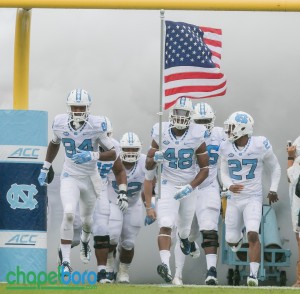The Tar Heels charge out of the locker room. Photo by Smith Cameron Photography.
