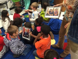 First-grade students at Estes Hill Elementary looking at items in gift package from President Barack Obama. Photo via Blake Hodge.