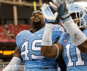Clarke (left) picked up the fumble forced by Malik Carney late in Saturday's win over Miami--sealing the win for UNC in the process. (Smith Cameron Photography)