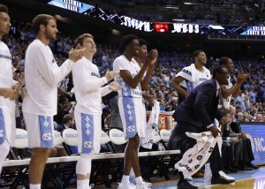 Whenever UNC has made big plays this season, Pinson (in suit) has consistently been the first to stand and cheer. (Todd Melet) 