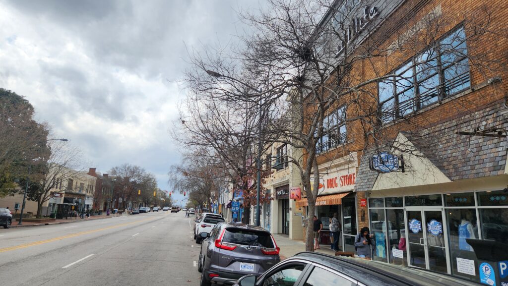 A photo by Geoffrey Neal of East Franklin Street in Chapel Hill, N.C., featuring trees and storefronts